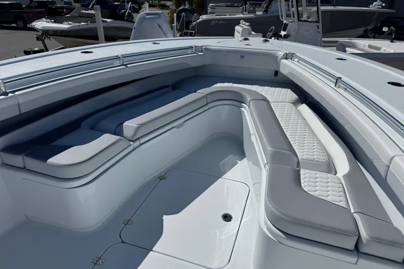 Slide: The Image of 2026 Yellowfin 36 Offshore boat interior with cushioned seating and sleek design. - 26