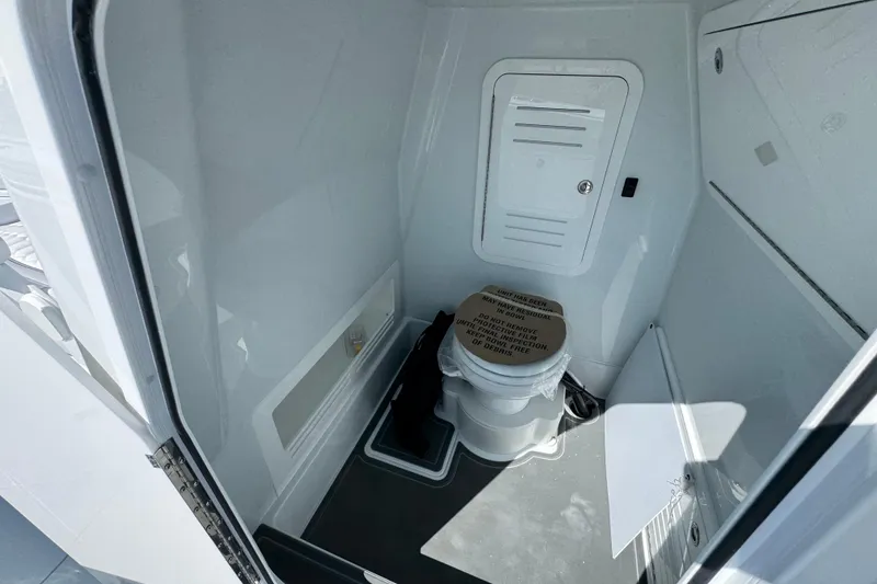 Slide: The Image of Interior of 2026 Yellowfin 36 Offshore boat featuring a compact marine toilet. - 31