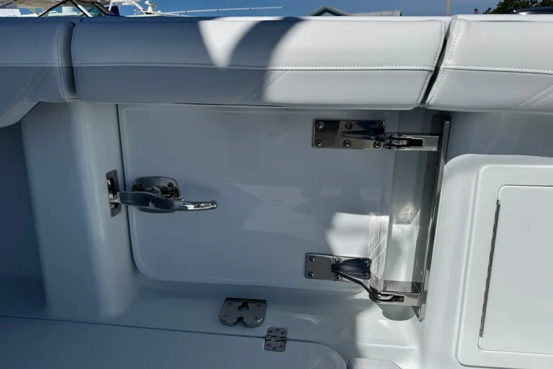 Slide: The Image of 2026 Yellowfin 36 Offshore boat interior with stainless steel hardware and white upholstery. - 32