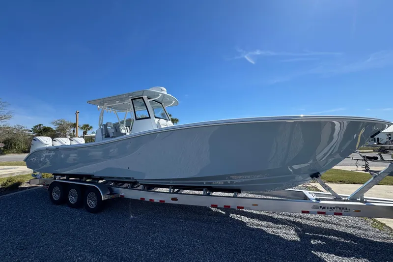 Slide: The Image of 2026 Yellowfin 36 Offshore boat on trailer under clear blue sky. - 7