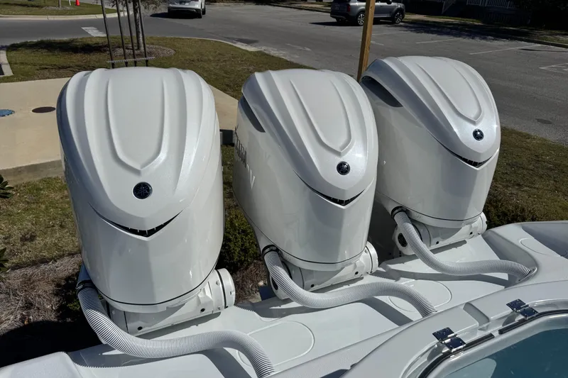 Slide: The Image of Triple outboard engines on a 2026 Yellowfin 36 Offshore boat, parked outdoors. - 9