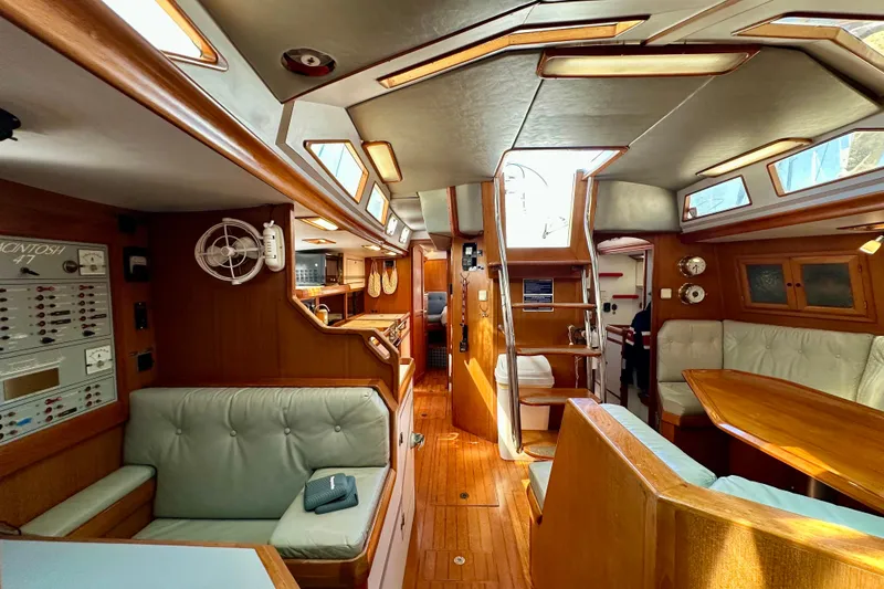 Slide: The Image of Interior of a 1987 Macintosh Center Cockpit yacht with wood paneling and seating. - 10