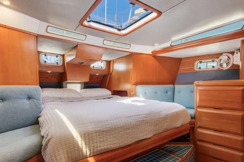 Slide: The Image of Cozy 1987 Macintosh Center Cockpit yacht bedroom with wood paneling and skylight. - 16
