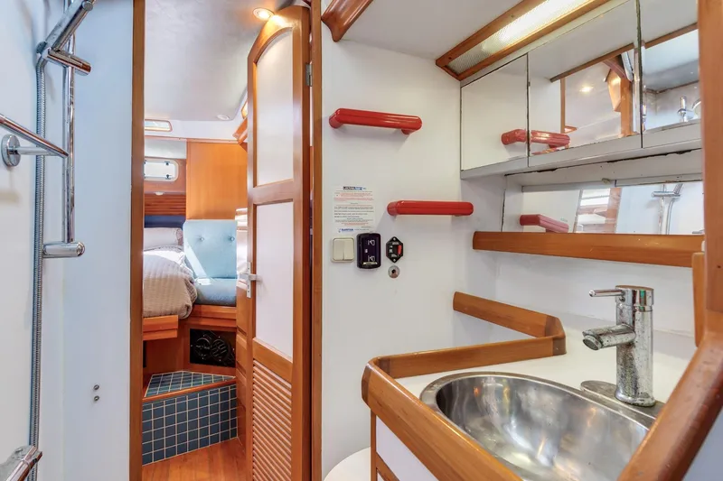 Slide: The Image of 1987 Macintosh Center Cockpit yacht interior with bathroom sink and cozy cabin view. - 19