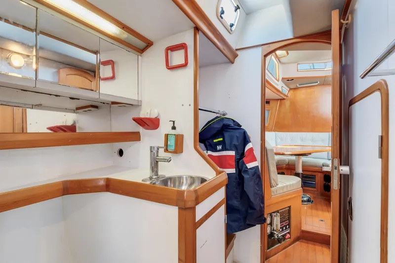 Slide: The Image of Interior of 1987 Macintosh Center Cockpit yacht with wooden finishes and compact design. - 21