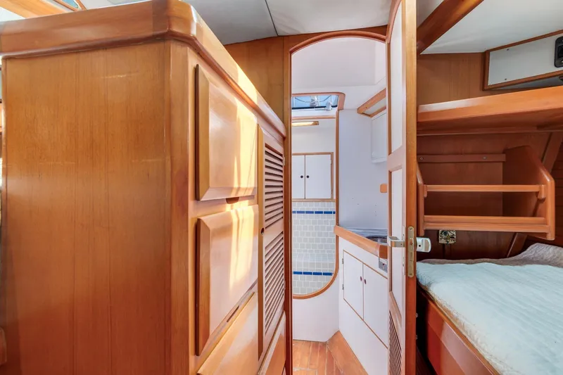 Slide: The Image of Interior of 1987 Macintosh Center Cockpit yacht with wooden cabinetry and cozy sleeping area. - 25