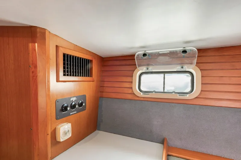 Slide: The Image of 1987 Macintosh Center Cockpit interior with wood paneling and ventilation controls. - 26