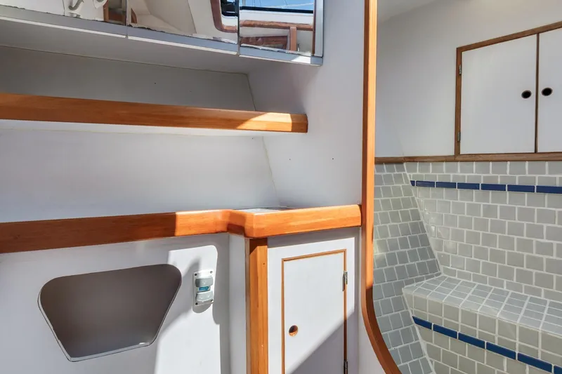 Slide: The Image of 1987 Macintosh Center Cockpit interior with wooden accents and tiled seating area. - 27