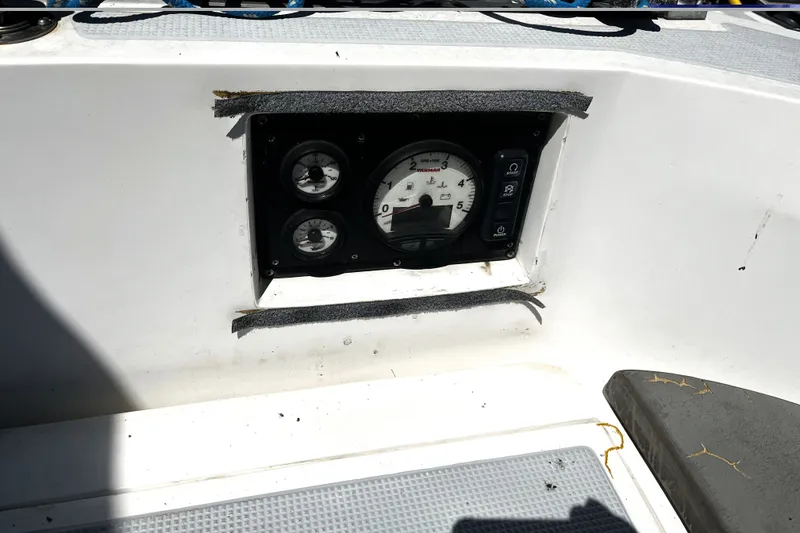 Slide: The Image of Instrument panel of a 1987 Macintosh Center Cockpit boat with gauges and switches. - 32