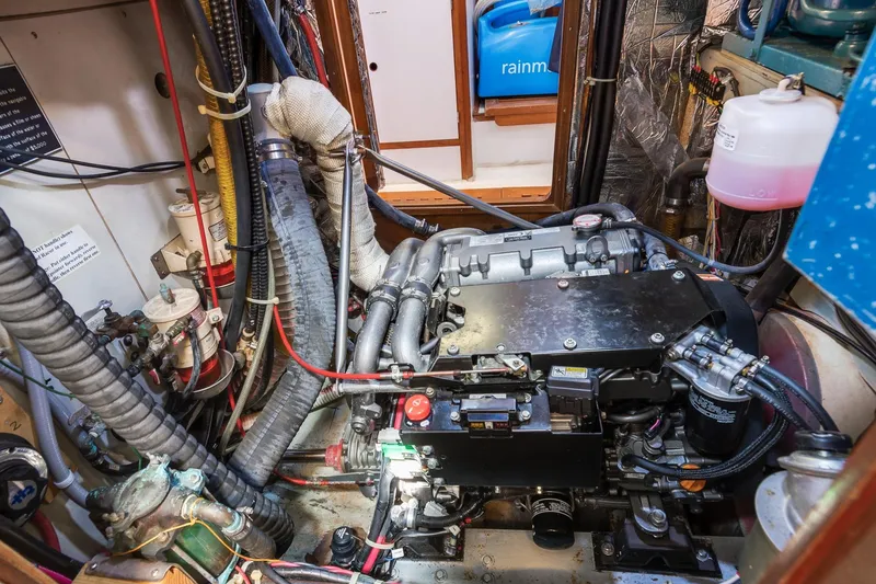 Slide: The Image of Engine room of a 1987 Macintosh Center Cockpit sailboat, showcasing complex machinery and components. - 33