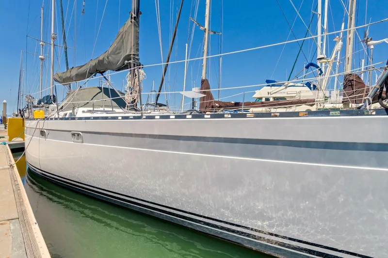 Slide: The Image of 1987 Macintosh Center Cockpit sailboat docked in marina under clear blue sky. - 41
