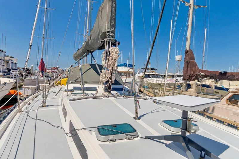 Slide: The Image of 1987 Macintosh Center Cockpit sailboat docked in a marina under clear blue skies. - 45