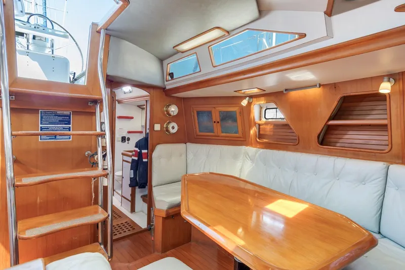Slide: The Image of Interior of 1987 Macintosh Center Cockpit yacht with wooden furnishings and seating area. - 5
