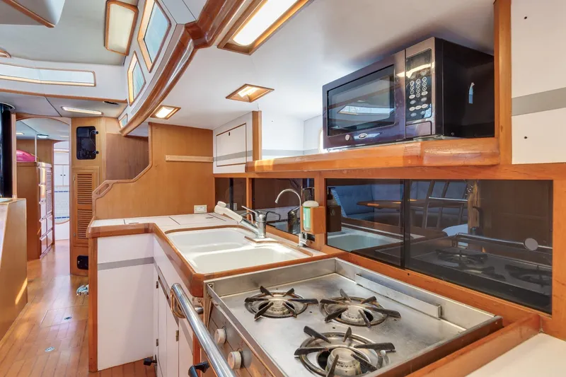 Slide: The Image of 1987 Macintosh Center Cockpit yacht kitchen with stove, sink, and microwave. - 8