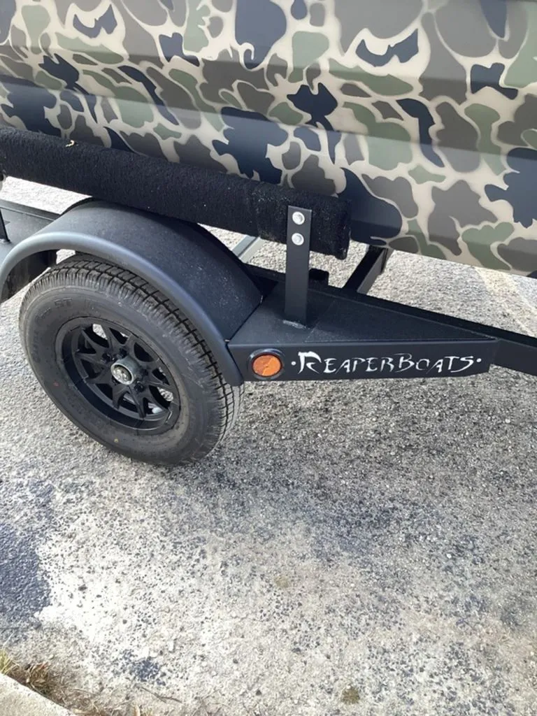Slide: The Image of Reaper 656 boat trailer with camouflage design, year 2026. - 11