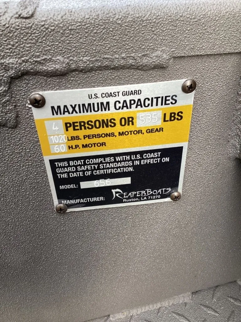 Slide: The Image of US Coast Guard capacity label on Reaper 656 boat, year 2026. - 18