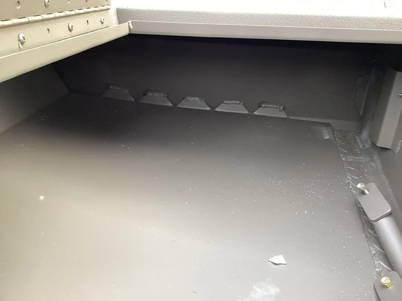 Slide: The Image of Interior of a 2026 Reaper 656, empty storage compartment. - 21