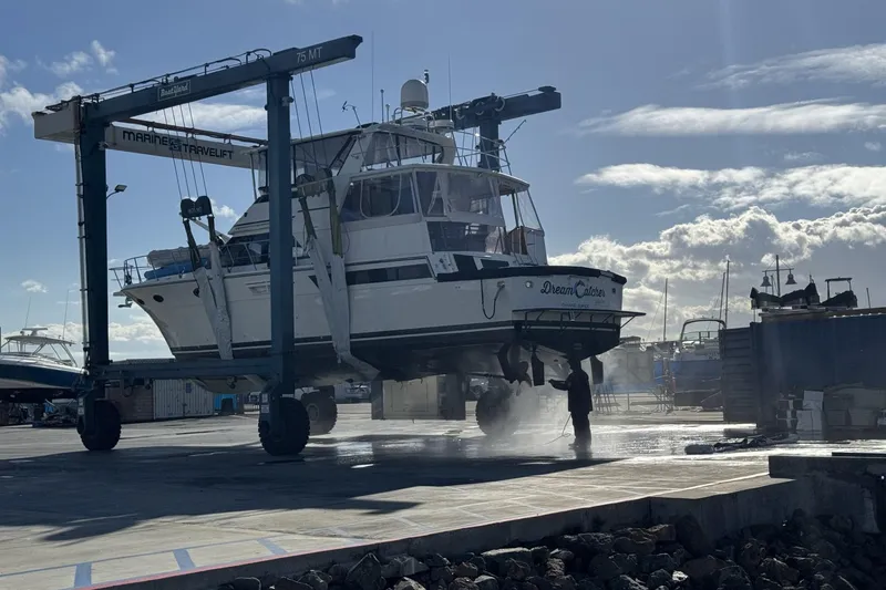 The Image of 1991 Californian 52 Cockpit Motor Yacht in dry dock for maintenance under clear skies. - 0