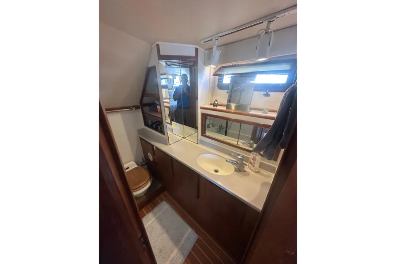 Slide: The Image of Bathroom interior of 1991 Californian 52 Cockpit Motor Yacht with sink, mirror, and toilet. - 10