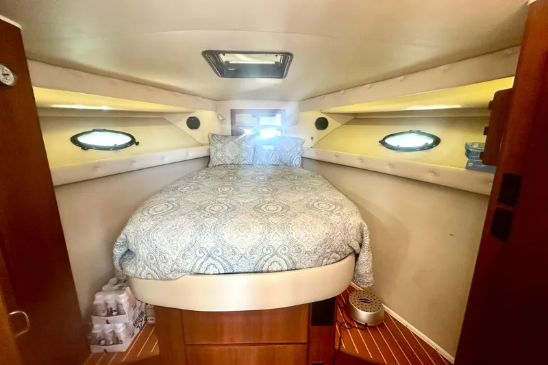 Slide: The Image of Cozy bedroom in 1991 Californian 52 Cockpit Motor Yacht with elegant bedding and porthole windows. - 11
