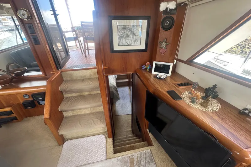 Slide: The Image of Interior of 1991 Californian 52 Cockpit Motor Yacht with wooden decor and stairs. - 13