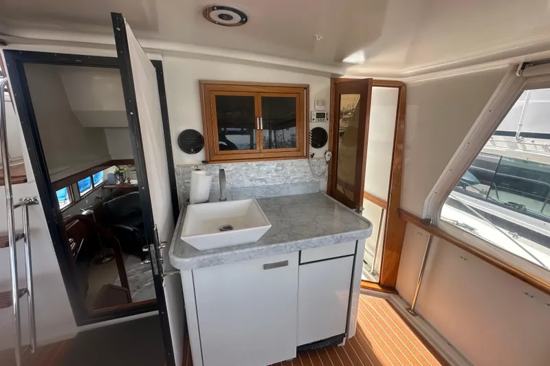 Slide: The Image of Interior of 1991 Californian 52 Cockpit Motor Yacht with modern sink and cabinetry. - 17