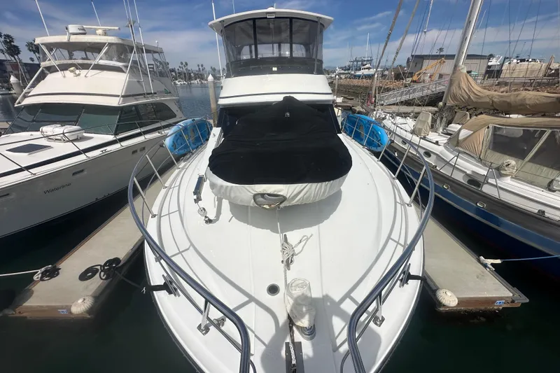 Slide: The Image of 1991 Californian 52 Cockpit Motor Yacht docked at marina, surrounded by other boats. - 19
