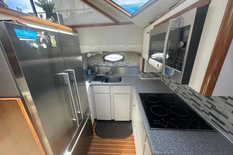 Slide: The Image of Modern kitchen in a 1991 Californian 52 Cockpit Motor Yacht with stainless steel appliances. - 2