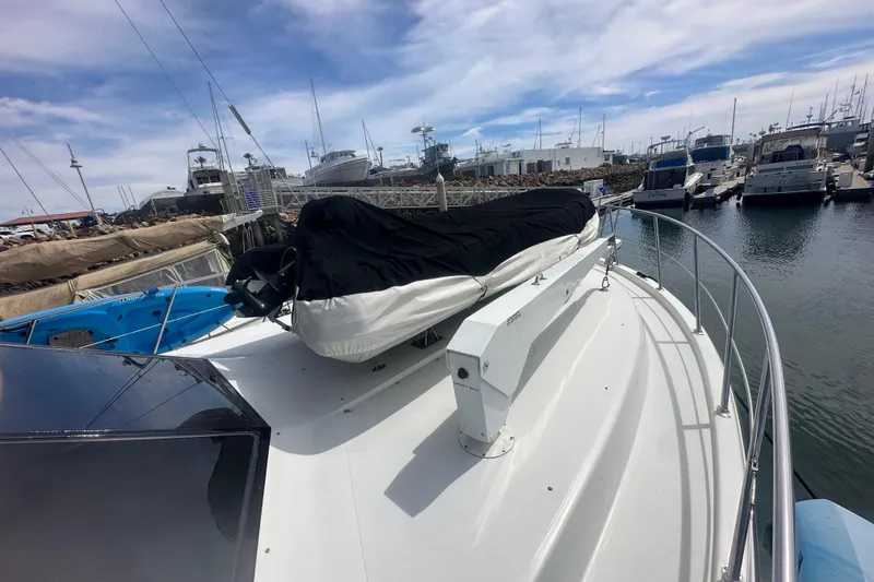 Slide: The Image of 1991 Californian 52 Cockpit Motor Yacht docked at marina under cloudy sky. - 20