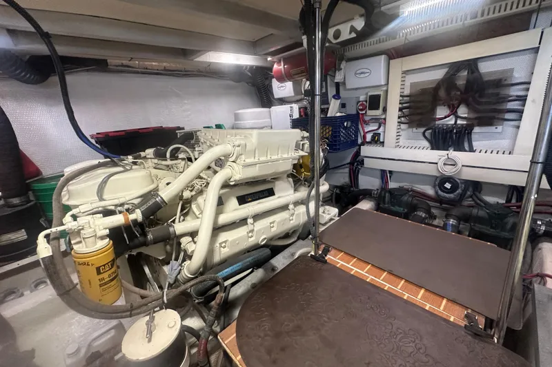 Slide: The Image of Engine room of a 1991 Californian 52 Cockpit Motor Yacht, featuring a CAT engine. - 23