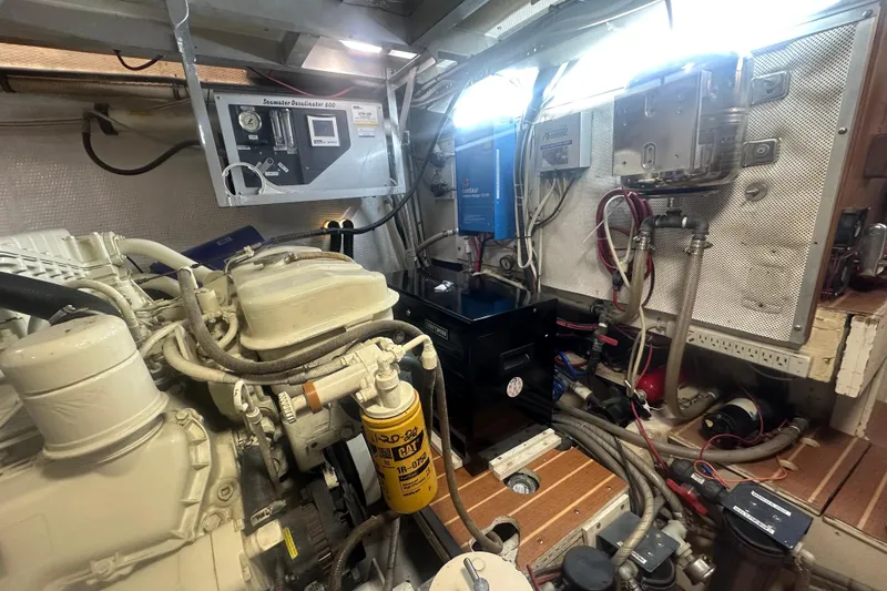 Slide: The Image of Engine room of 1991 Californian 52 Cockpit Motor Yacht with mechanical components and wiring. - 25