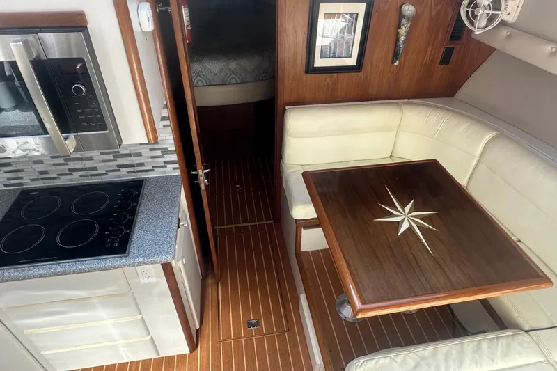 Slide: The Image of Interior of 1991 Californian 52 Cockpit Motor Yacht with kitchen and dining area. - 6