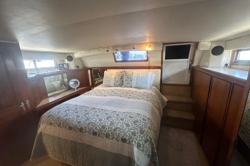 Slide: The Image of Luxurious bedroom interior of a 1991 Californian 52 Cockpit Motor Yacht with elegant bedding. - 8