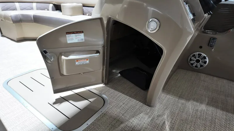 Slide: The Image of Interior of 2019 Bennington SXP SERIES 23SS with open storage compartment. - 39