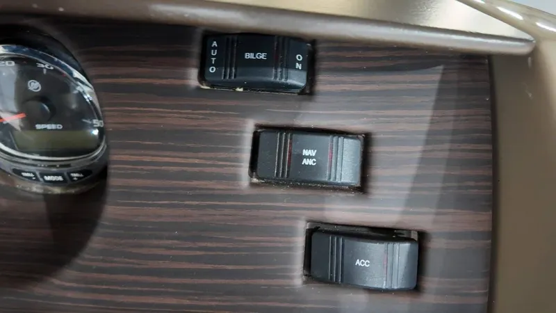 Slide: The Image of Dashboard of 2019 Bennington SXP SERIES 23SS with switches and speedometer. - 44