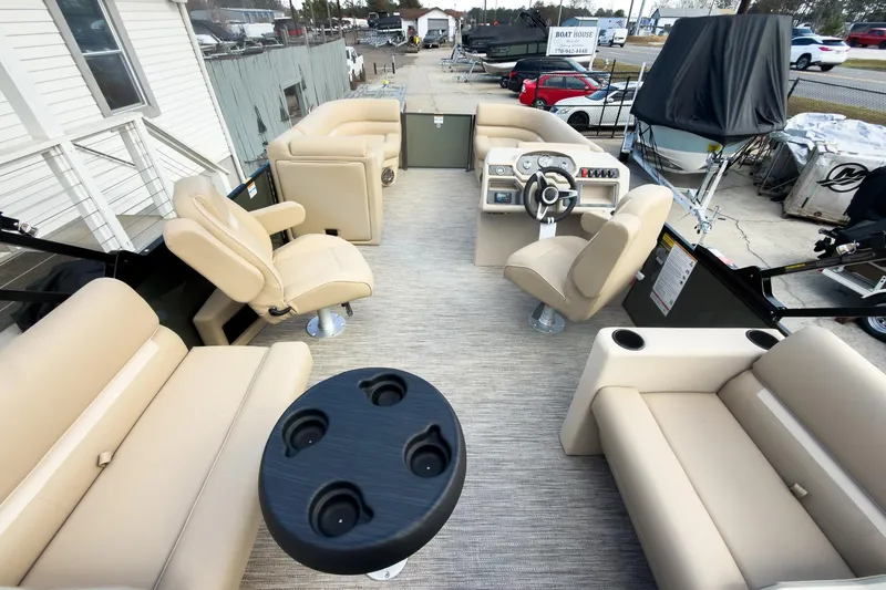 Slide: The Image of 2026 Godfrey Sweetwater Xperience 22' Split Bench Pontoon with beige seating and steering console. - 28