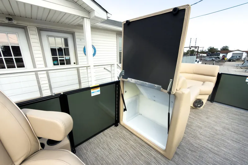 Slide: The Image of 2026 Godfrey Sweetwater Xperience 22' Pontoon with open storage compartment and beige seating. - 29
