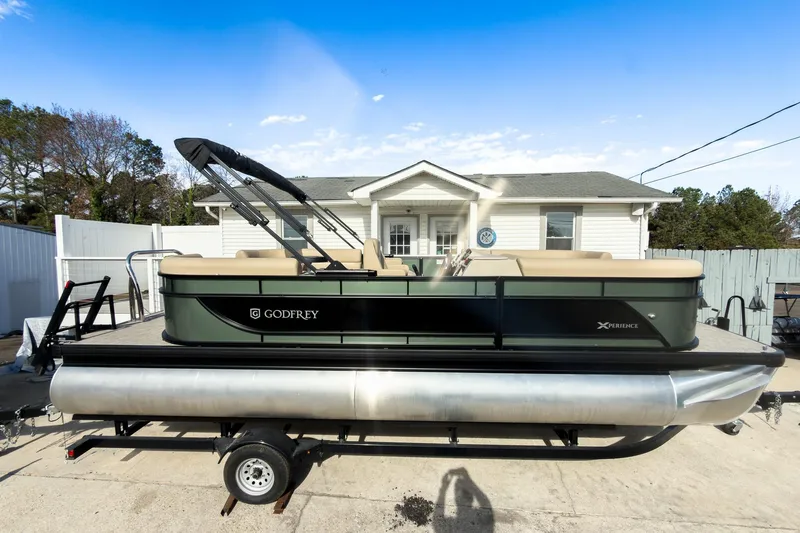 Slide: The Image of 2026 Godfrey Sweetwater Xperience 22' Split Bench Pontoon on trailer, parked in driveway. - 5