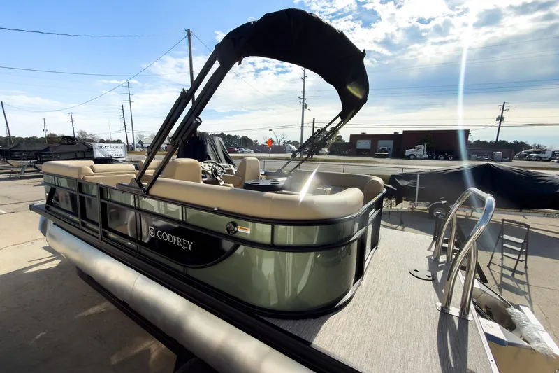 Slide: The Image of 2026 Godfrey Sweetwater Xperience 22' Split Bench Pontoon with canopy, parked outdoors. - 7