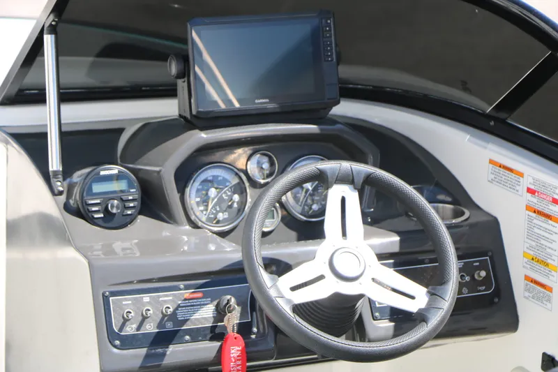 Slide: The Image of Dashboard of a 2022 Bayliner VR5 boat with steering wheel and instruments. - 16