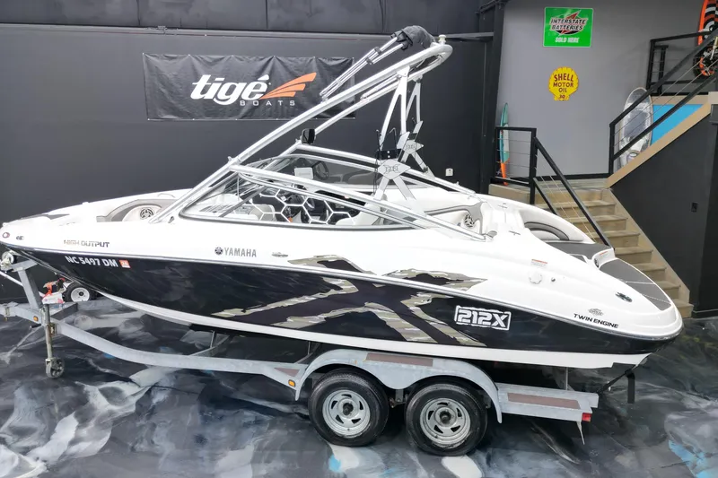 Slide: The Image of 2008 Yamaha Boats 212X on trailer in showroom, featuring sleek design and twin engines. - 15