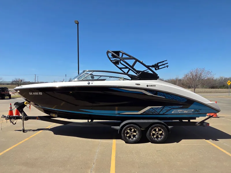 Slide: The Image of 2021 Yamaha Boats 252XE parked outdoors on a trailer. - 5