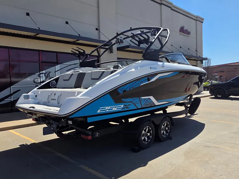 Slide: The Image of 2021 Yamaha Boats 252XE on trailer outside building. - 8