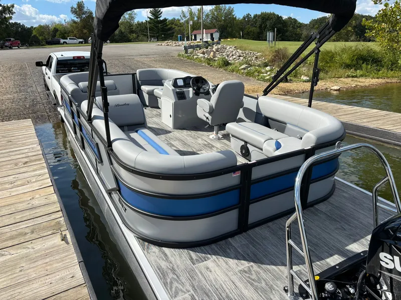 Slide: The Image of 2026 Bentley Pontoons 223 Bolt on a boat trailer by the lake. - 40
