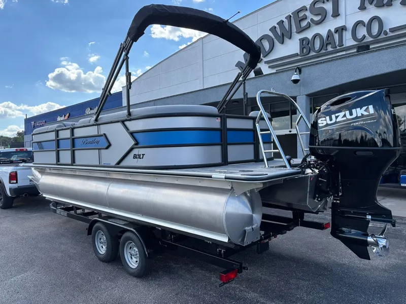 Slide: The Image of 2026 Bentley Pontoons 223 Bolt with Suzuki engine at a boat dealership. - 7
