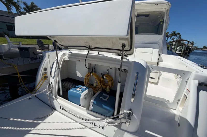 Slide: The Image of 2005 Tiara Yachts 3600 Sovran with open storage compartment, docked by waterfront. - 10