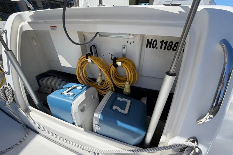 Slide: The Image of Storage compartment of 2005 Tiara Yachts 3600 Sovran with coolers and hoses. - 11