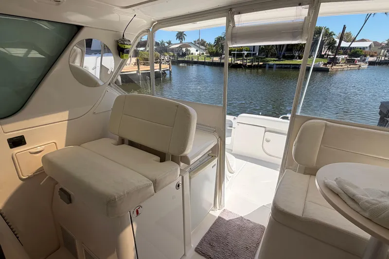 Slide: The Image of Interior view of 2005 Tiara Yachts 3600 Sovran, featuring comfortable seating and waterfront backdrop. - 15
