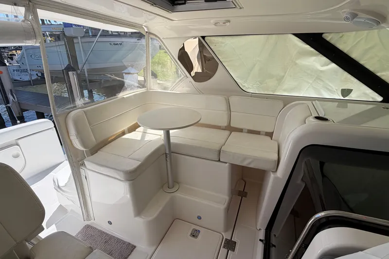 Slide: The Image of 2005 Tiara Yachts 3600 Sovran interior with white seating and round table. - 16