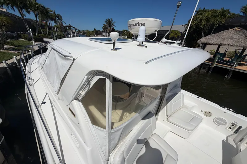 Slide: The Image of 2005 Tiara Yachts 3600 Sovran docked, showcasing sleek design and spacious deck area. - 2